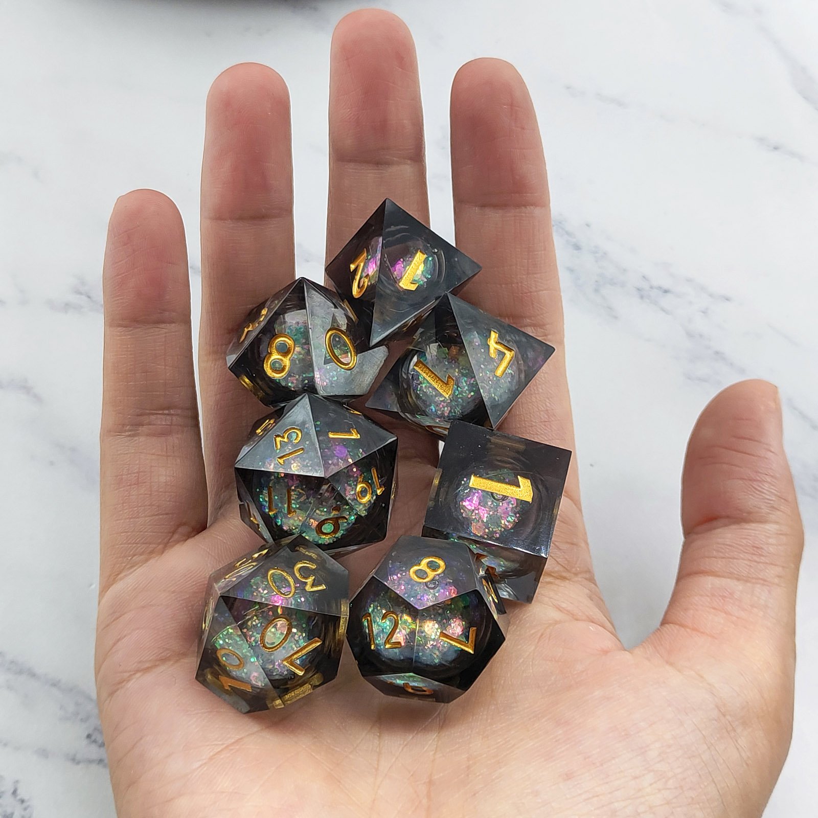 LCD251125B-black-gold-05-liquid-core-dice-in-hand