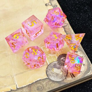 pink resin dice with gold numbers